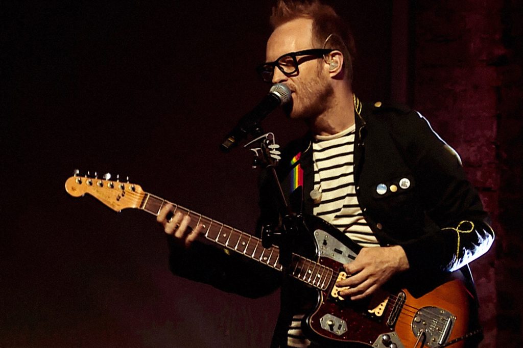 Me, playing a left-handed fender jaguar on stage at TEDxWarsaw